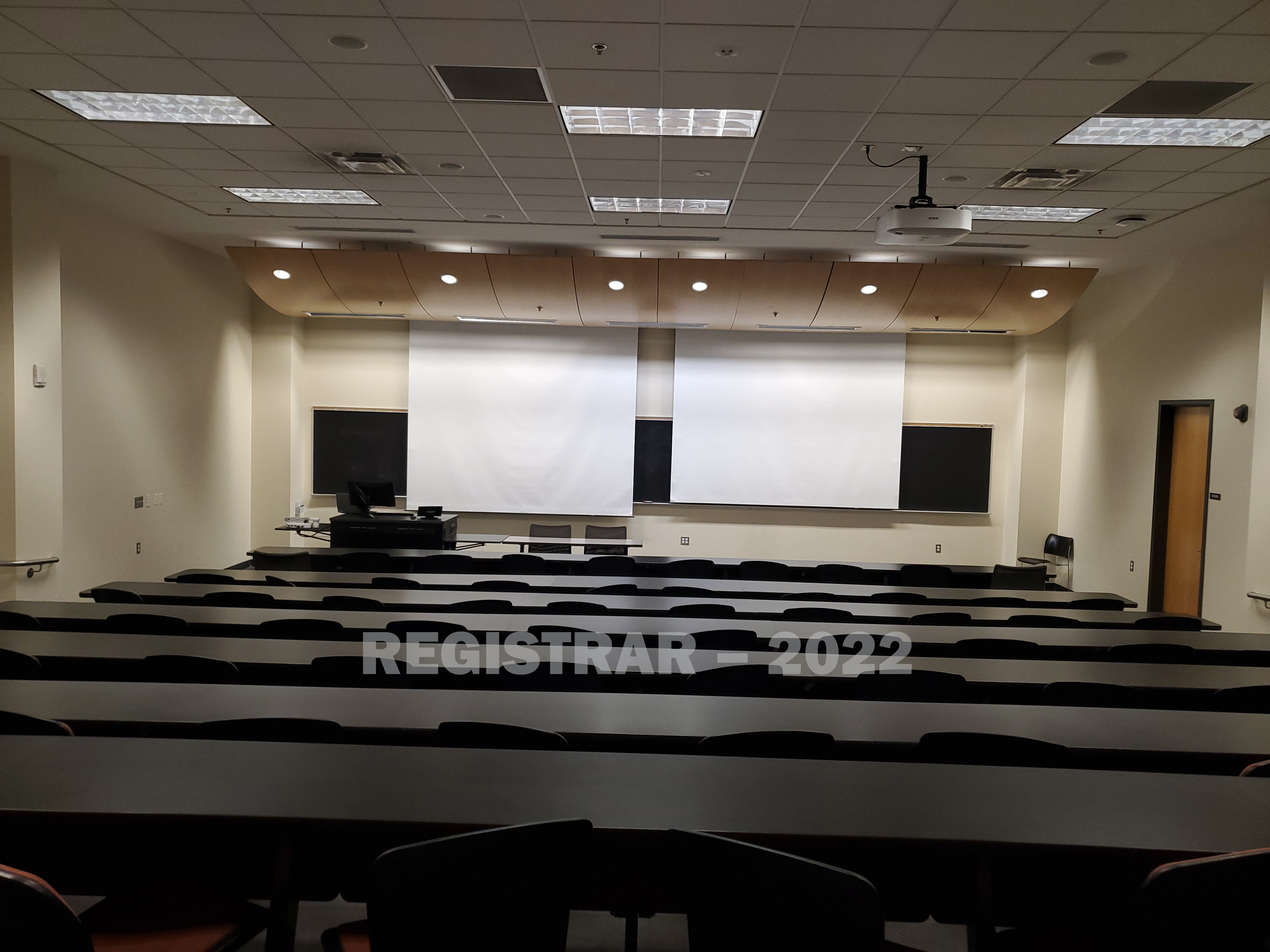 Scott Lab room East 125 view from the back of the room with projector screen down