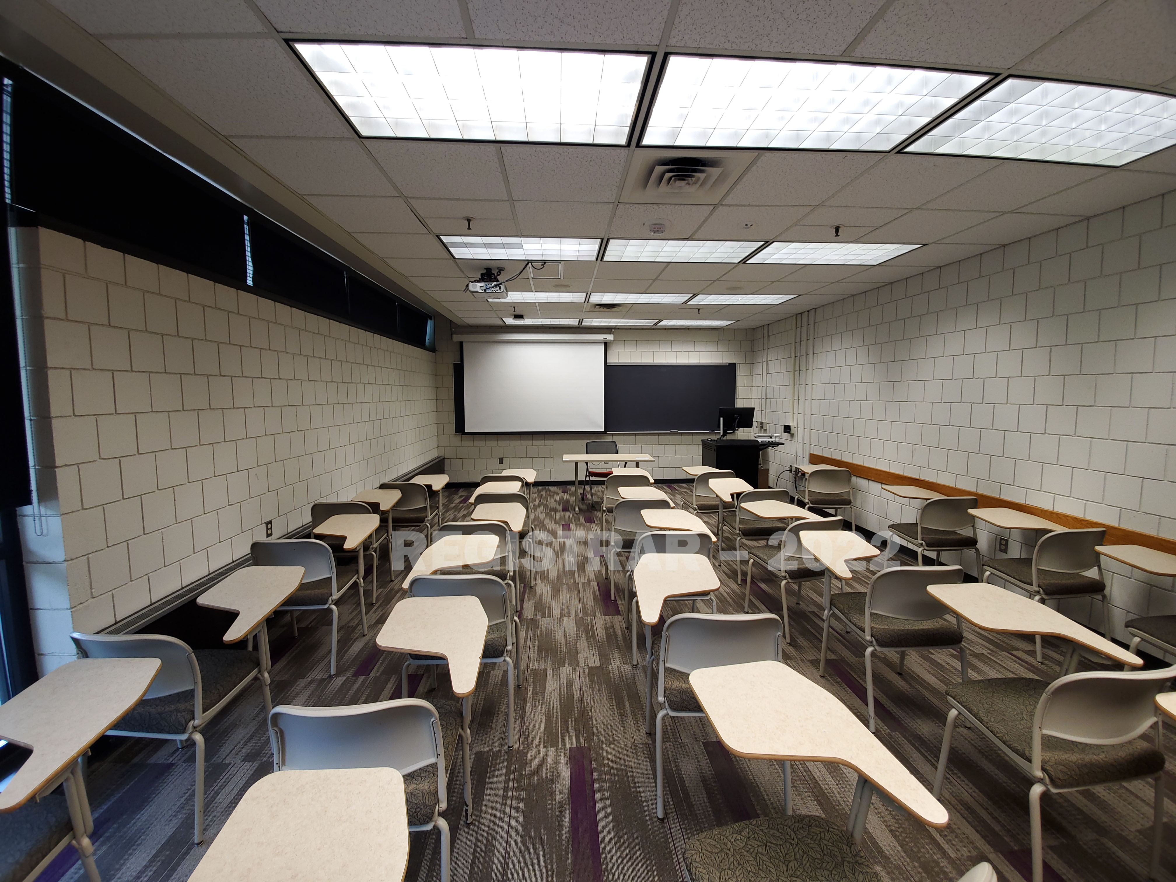 Kottman Hall room 116 ultra wide angle view from the back of the room with projector screen down