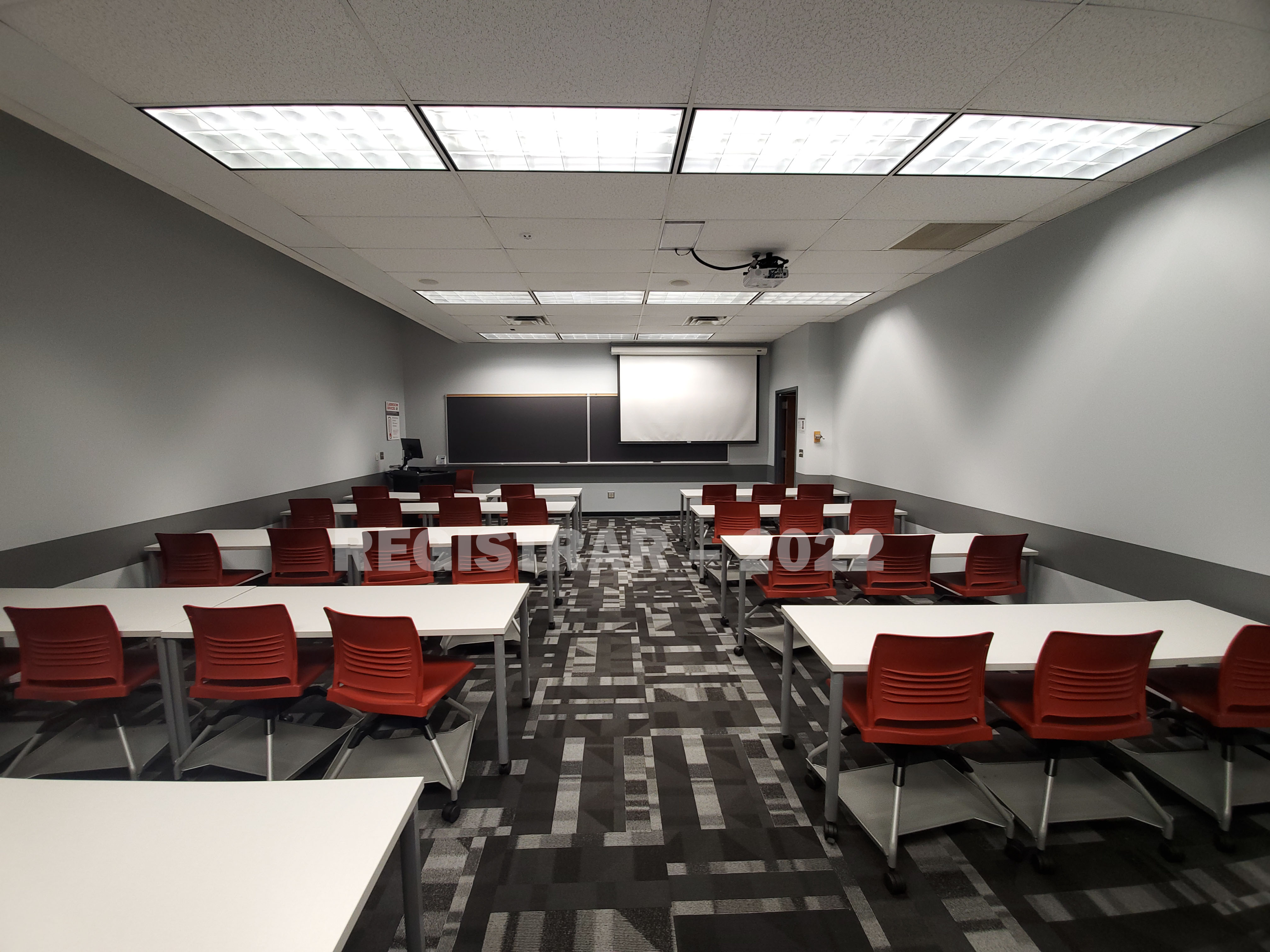 Derby Hall room 48 ultra wide angle view from the back of the room with projector screen down
