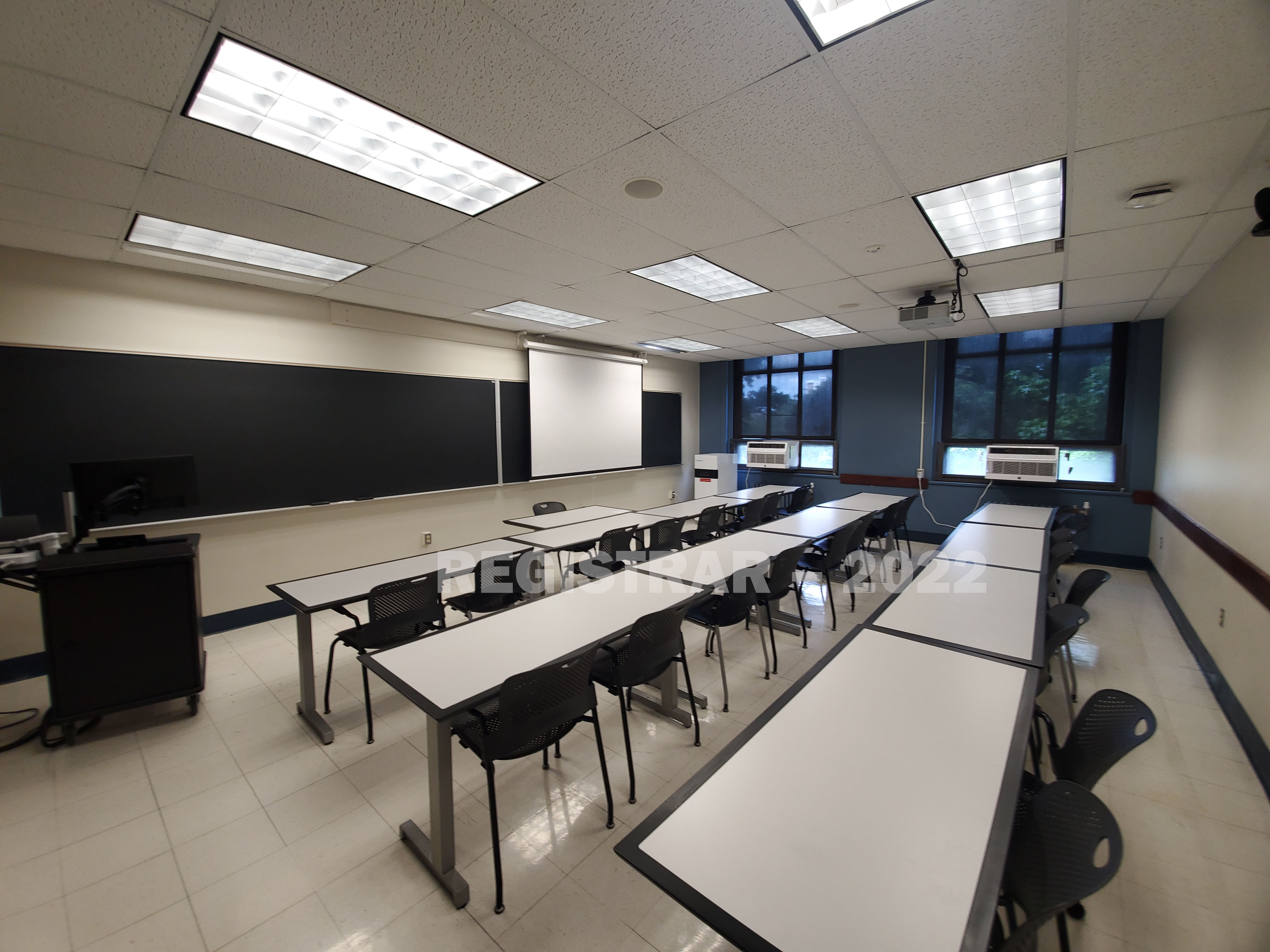 Coockins Hall room 228 ultra wide angle view from the back f the room with projector screen down