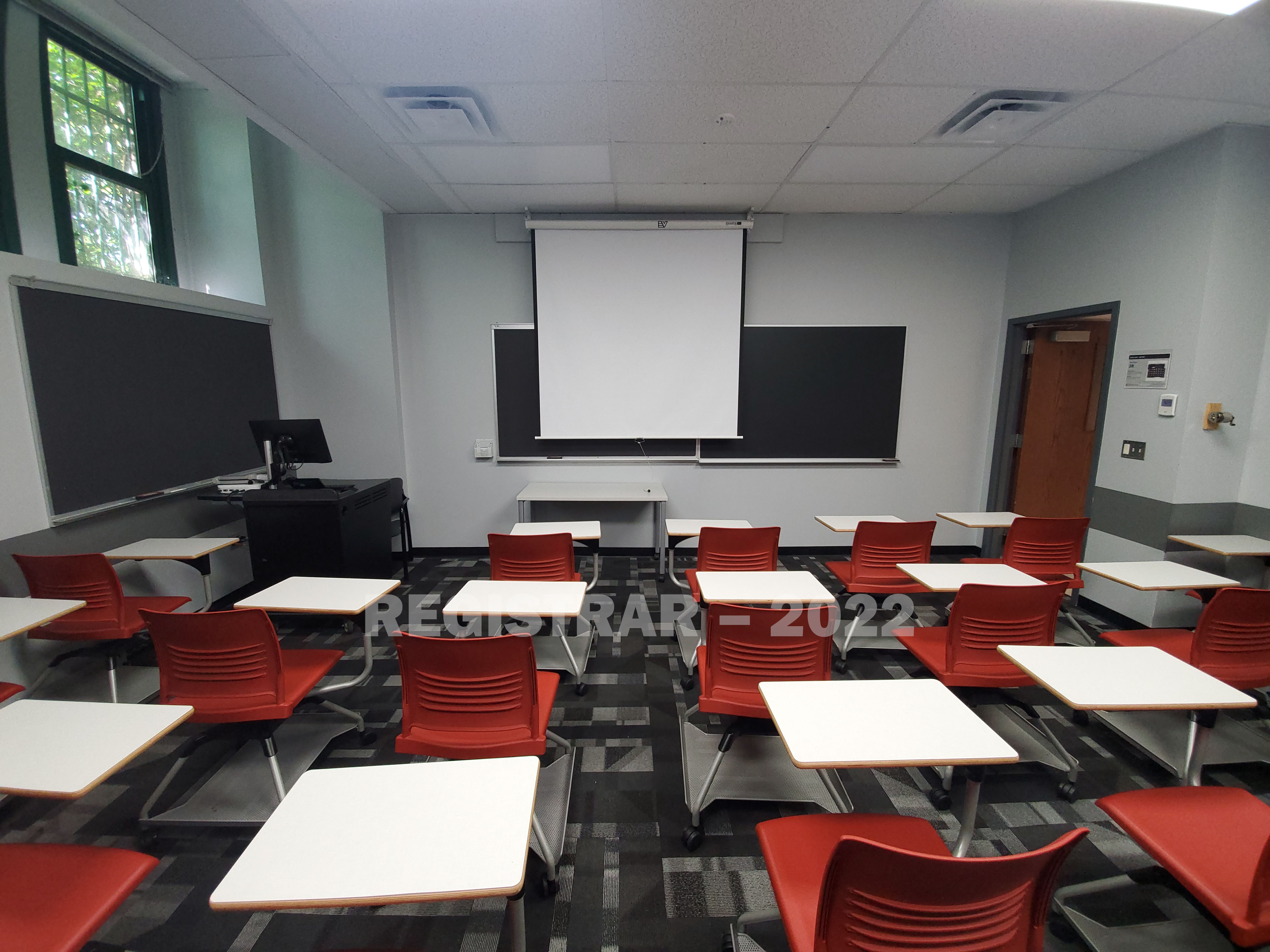 Derby Hall room 30 ultra wide view from the back of the room with projector screen down