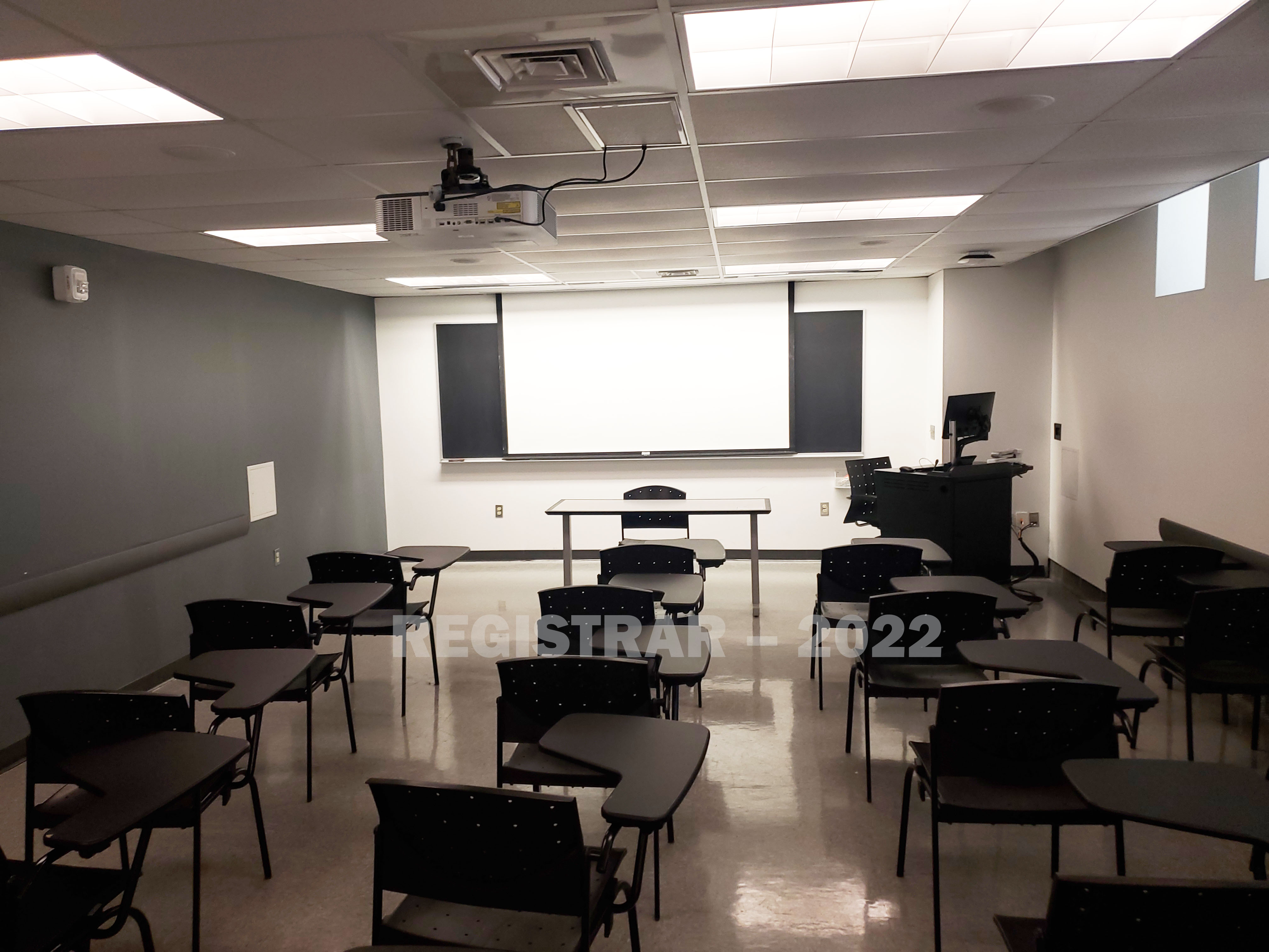 Hayes Hall room 12 view from the back of the room with projector screen down