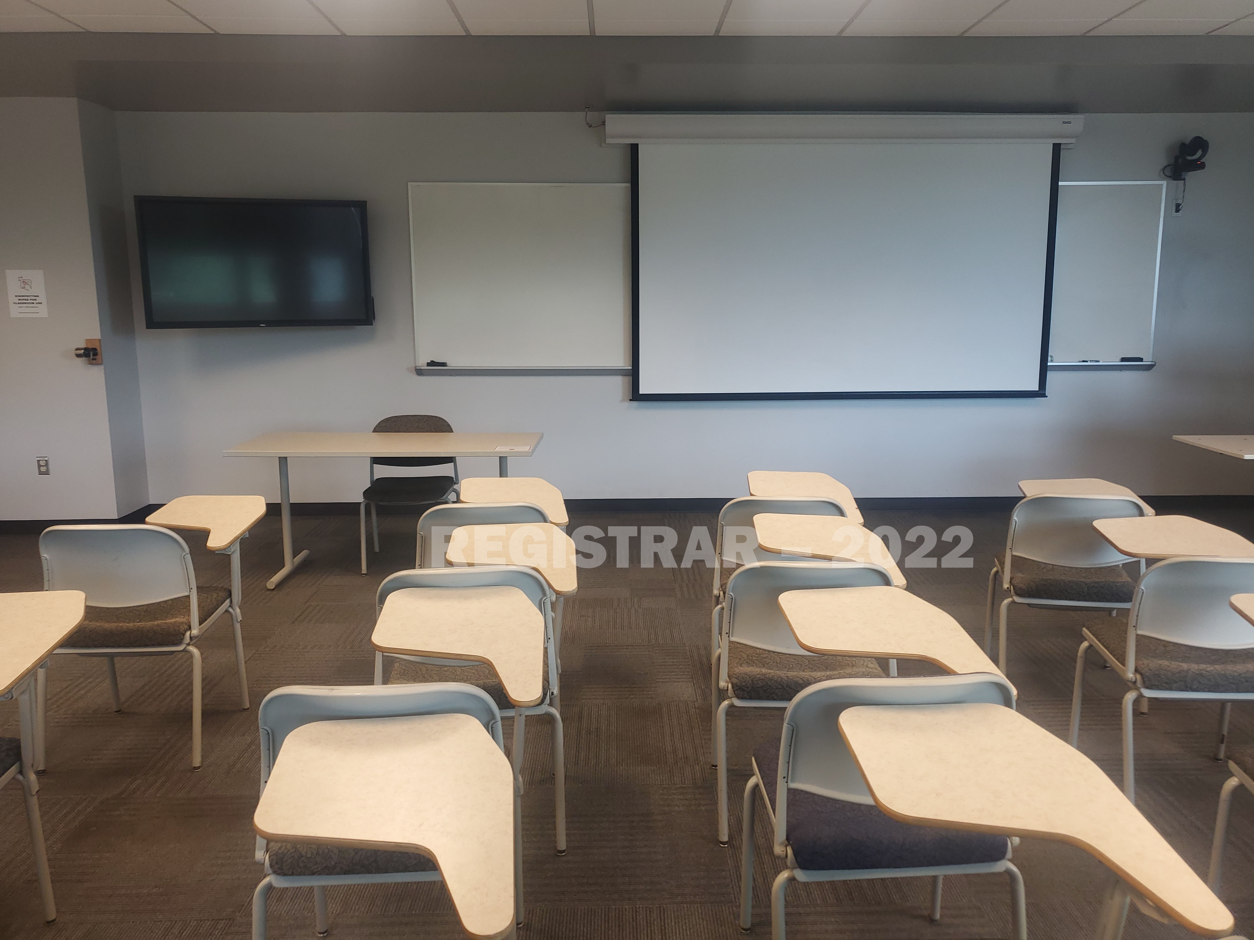 Agricultural Administration room 246 view from the back of the room with projector screen down