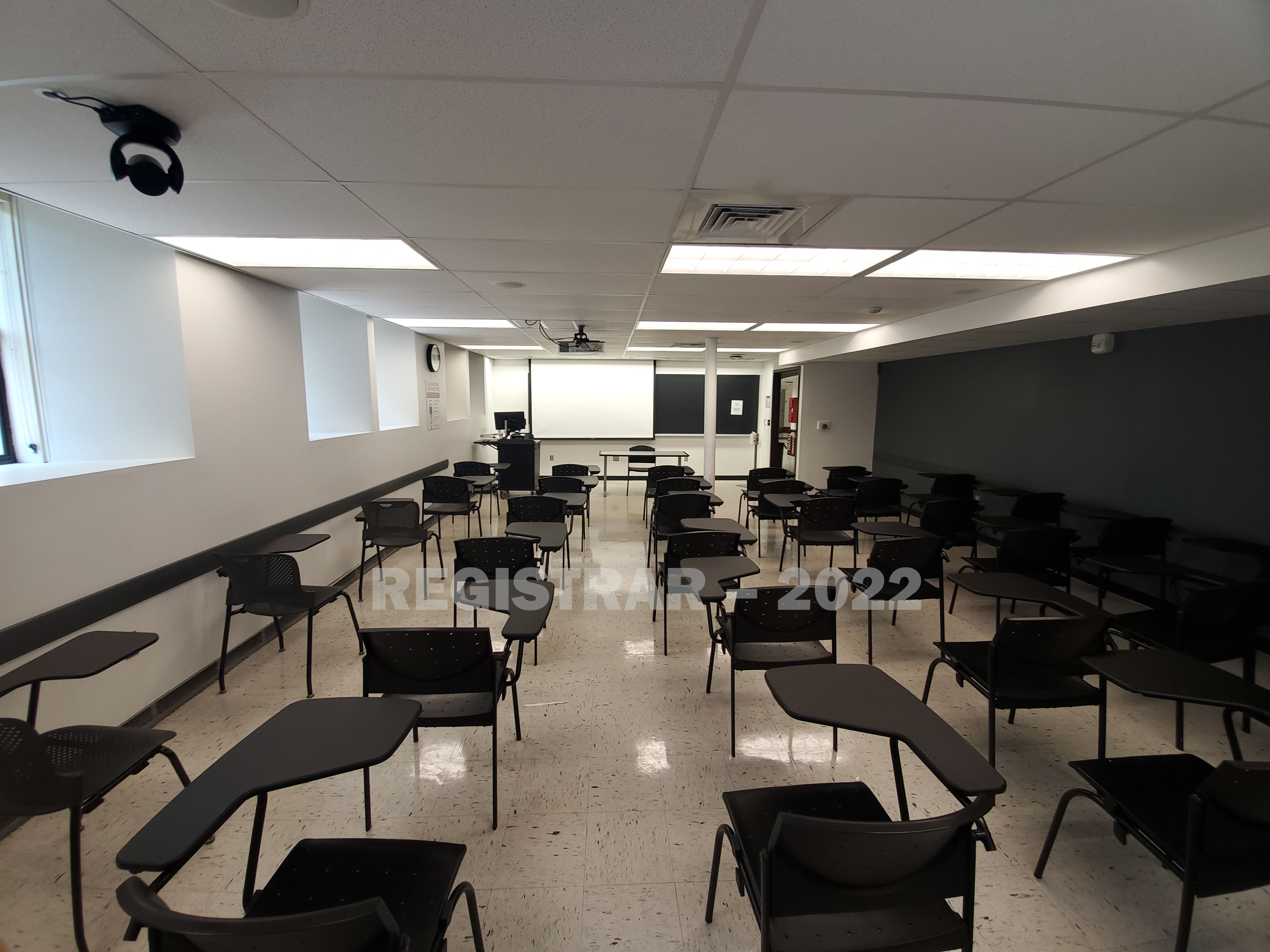 Hayes Hall room 6 view from the back of the room with projector screen down