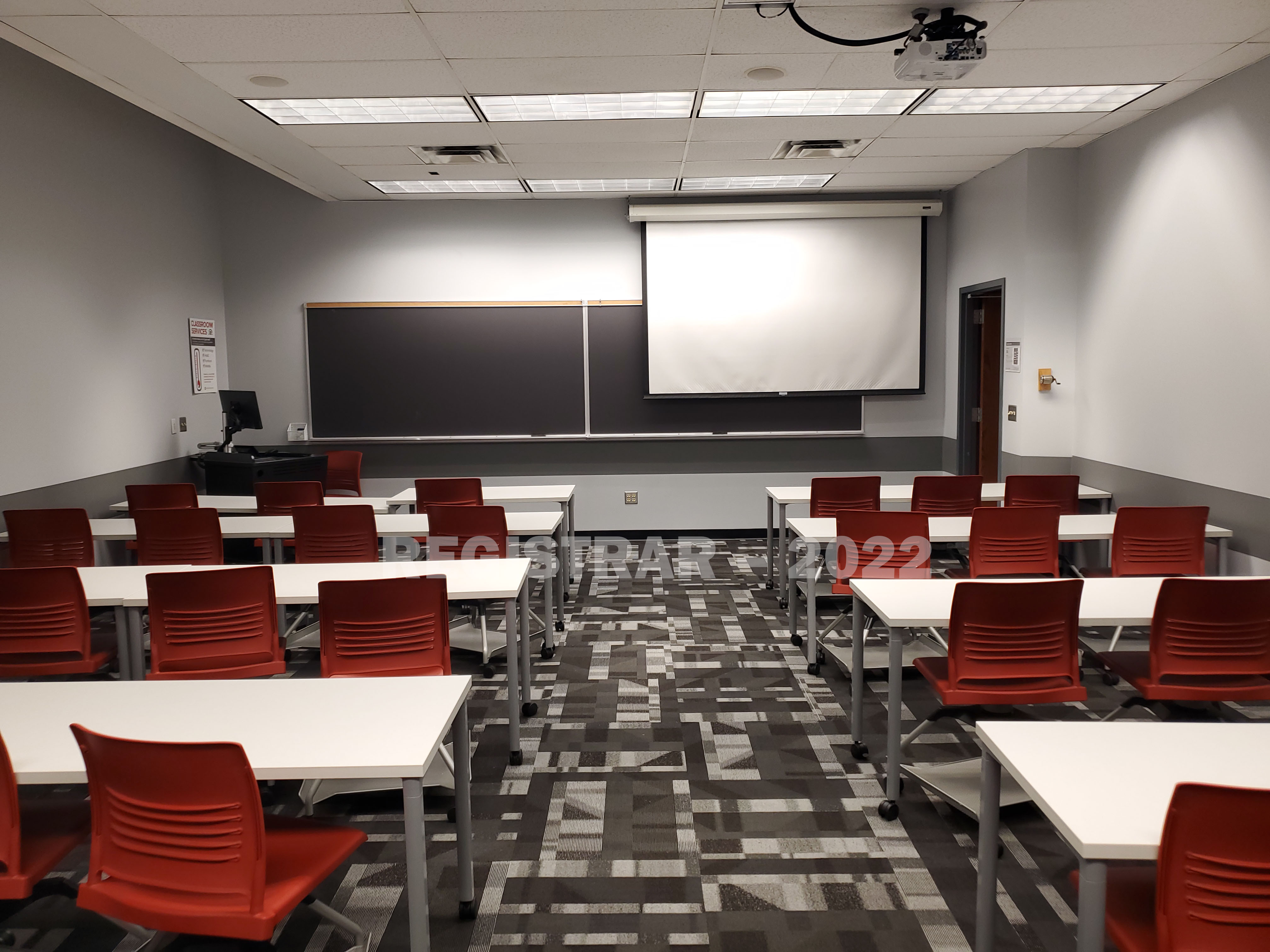 Derby Hall room 48 view from the back of the room with projector screen down