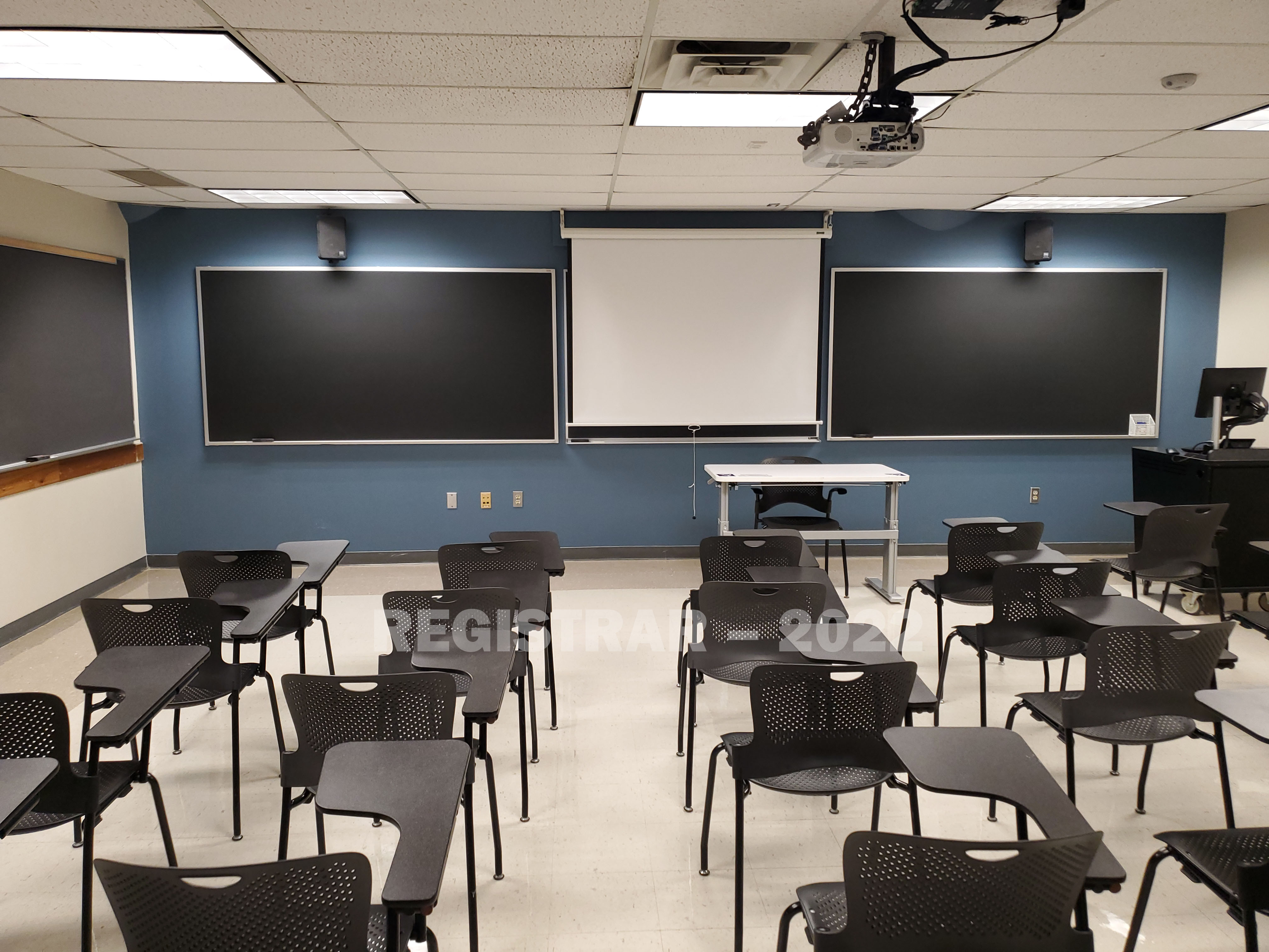 Enarson Classroom Building room 245 view from the back of the room with projector screen down