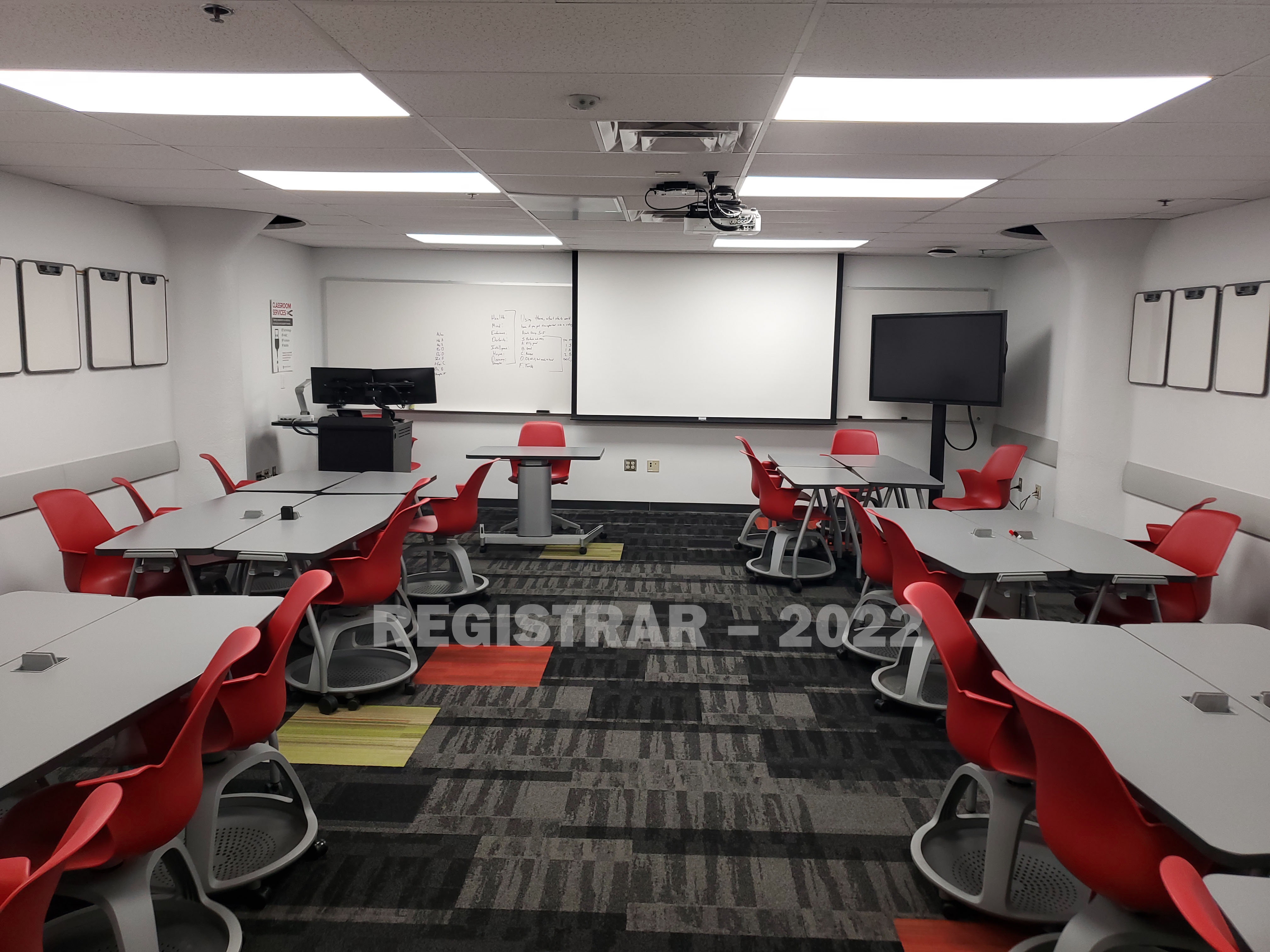Enarson Classroom Building room 14 view from the back of the room with projector screen down